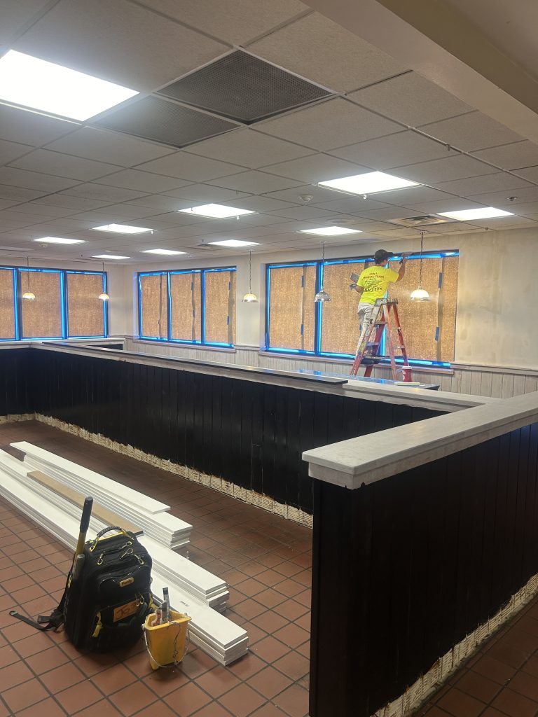 professional-painter-paints-trim-in-office-building