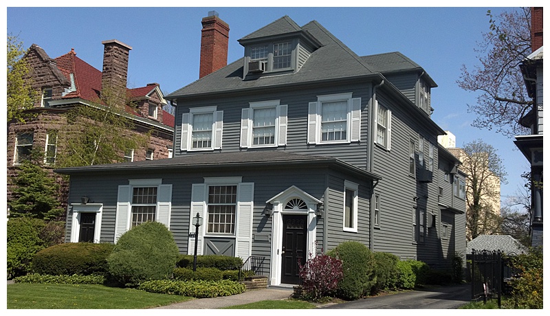 North Buffalo home with grey vinyl siding painted by Paint of WNY