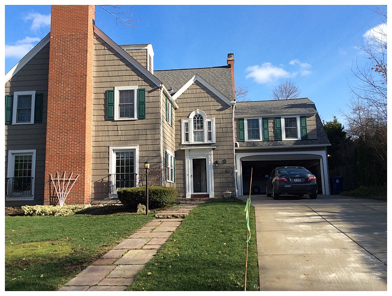 Painted vinyl siding exterior residential project with green shutters